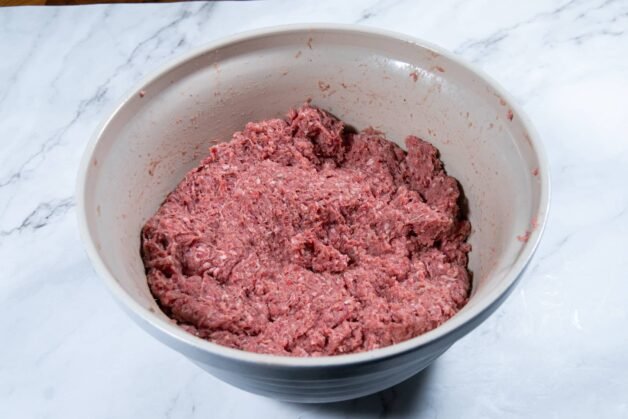 Ground meat mixture in a bowl, ready for shaping into cevapi.