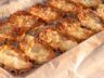 Crispy garlic bread slices with a golden cheesy topping, fresh out of the oven.