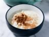 Traditional Brazilian mungunzá dessert served with a sprinkle of ground cinnamon.