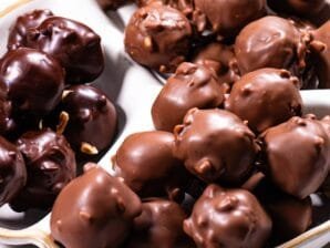 A white dish filled with Nutella Crunch Bites coated in dark and milk chocolate.