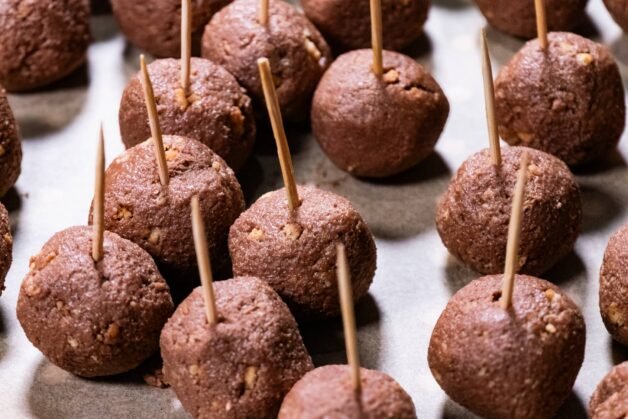 Chilled Nutella Crunch Bites with toothpicks inserted, ready for dipping in chocolate.