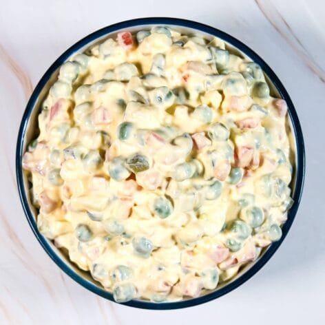 Top view of Classic Russian Salad in a bowl with creamy dressing.