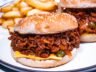 Sloppy Joes with melted cheese, pickles, and toasted buns.