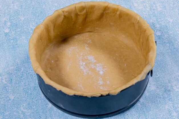 Dough-lined springform pan, ready as the base for the creamy chicken and mushroom pie.