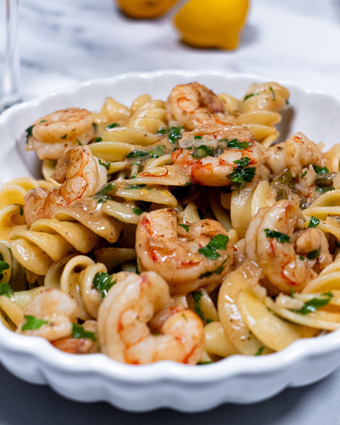 Close-up of Mediterranean shrimp pasta with fusilloni, fresh parsley, and lemon sauce.