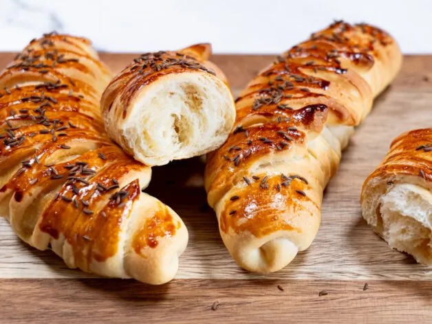 Homemade crescent rolls cut open to show soft, airy interior
